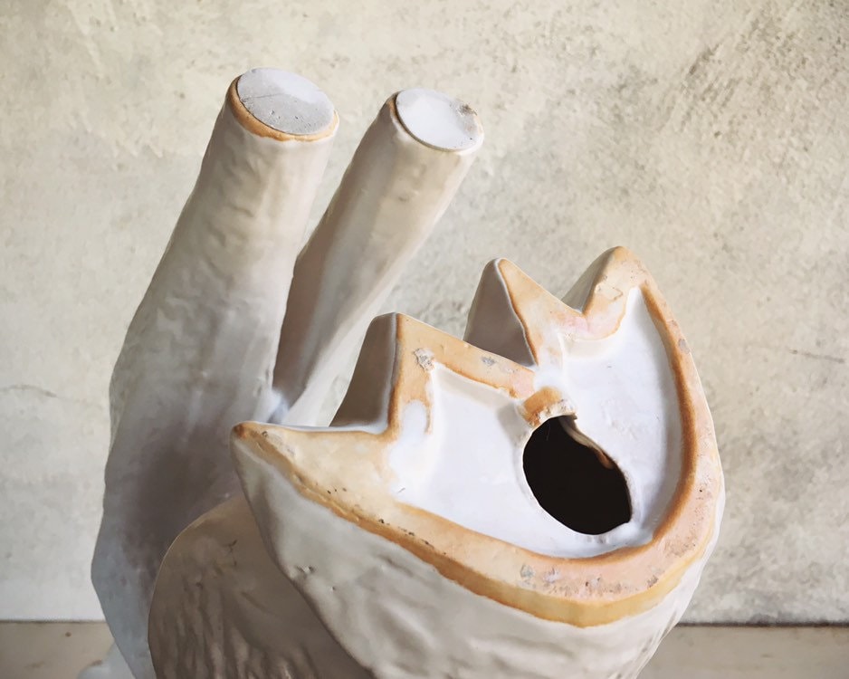 white ceramic greyhound statue