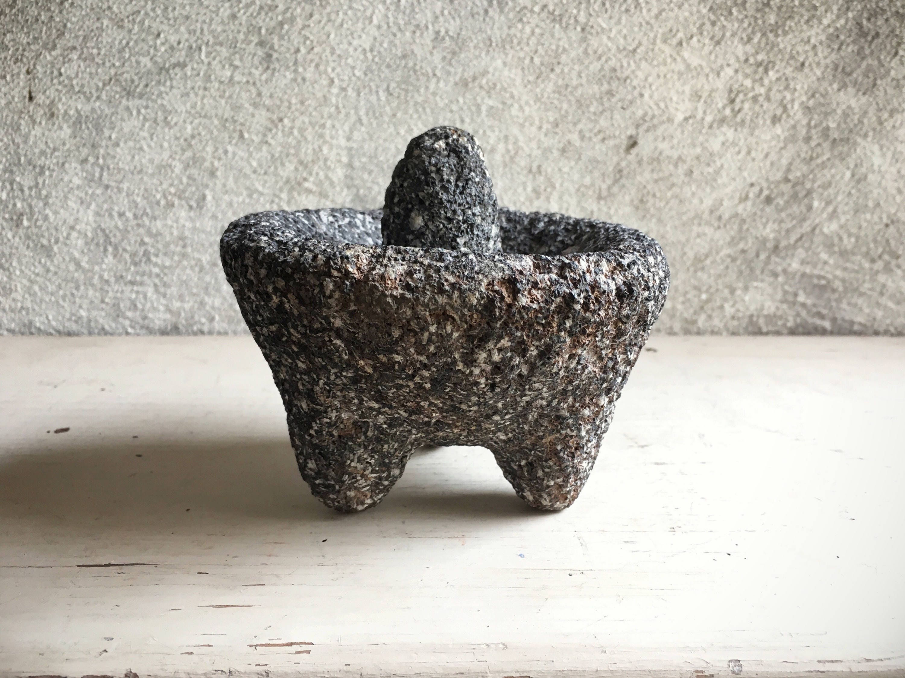 Vintage Mexican grinding stone bowl or metate made of lava rock mortar