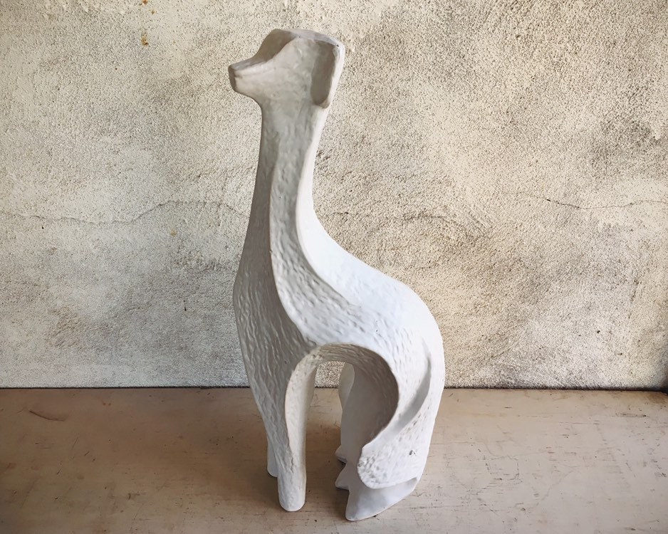 white ceramic greyhound statue