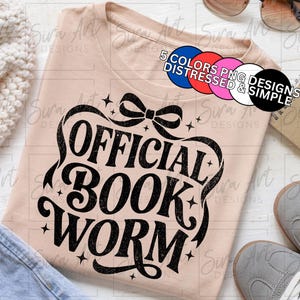 May include: A light pink t-shirt with the words "OFFICIAL BOOK WORM" in a black, decorative font. The shirt is surrounded by a bow and stars. The image also includes a pair of gray sneakers, a notebook, and sunglasses.