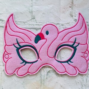 May include: Pink felt flamingo mask with black eye details and a pink felt beak.