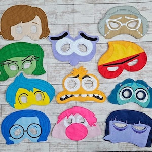 May include: Set of ten felt face masks featuring characters from the animated film Inside Out. The masks are colourful and feature various expressions, including happy, sad, angry, scared, and disgusted.