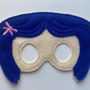 May include: Blue felt eye mask with a pink flower detail. The mask is shaped like a girl's face with a blue wig.