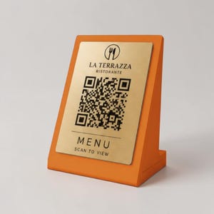May include: An orange table menu holder with a gold-colored plate. The plate has the restaurant name "La Terrazza Ristorante", a QR code, and the word "MENU" with "SCAN TO VIEW" below it.