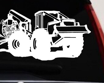 May include: A white vinyl decal featuring a detailed silhouette of a forestry skidder machine. The graphic depicts the heavy-duty vehicle with large treaded tires, a front blade, and a rear grapple arm actively clutching a bundle of harvested logs.
