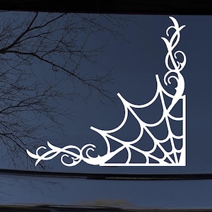 May include: White vinyl decal of a spider web with intricate details, perfect for adding a spooky touch to a car window or other smooth surface.