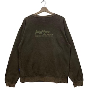 May include: A brown sweatshirt with a green and yellow "KENZO JEANS" logo on the back.