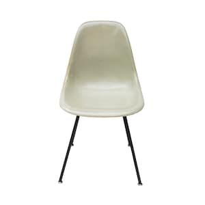 May include: A light green fiberglass chair with black metal legs. The chair has a simple, modern design.