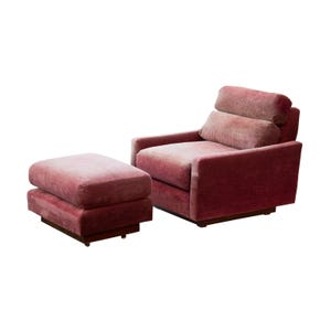 May include: A pink velvet armchair with a matching ottoman. The chair has a high back and a tufted cushion. The ottoman is square and has a smooth surface.