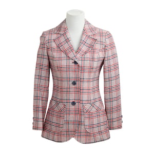 May include: A red, white, and blue plaid blazer with a notched collar, three buttons, and two flap pockets.