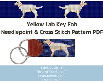 May include: A key fob featuring a yellow Labrador Retriever design on a blue background. The key fob has a brown leather backing and silver key rings. The text "Yellow Lab Key Fob" and "Needlepoint & Cross Stitch Pattern PDF" are also visible.