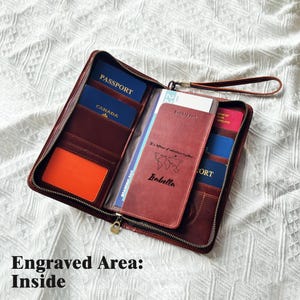 May include: Open leather travel wallet in a rich brown color, featuring multiple compartments for passports and cards. The wallet is open, revealing passports from various countries. A personalized passport cover is visible, with the name "Isabella" and a world map design.