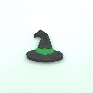 May include: A black witch hat with a green band. The hat has a pointed crown and a wide, circular brim. The hat is a Halloween decoration.