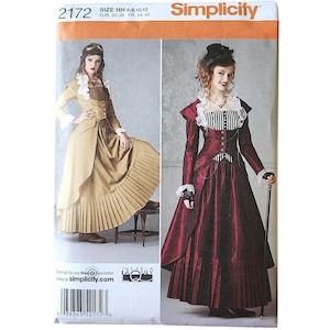 May include: Simplicity sewing pattern 2172, size HH 6, 8, 10, 12. The envelope features two long-sleeved dresses with pleated skirts, ruffled collars, and fitted bodices. One dress is tan, and the other is deep red with a black and white striped bodice.