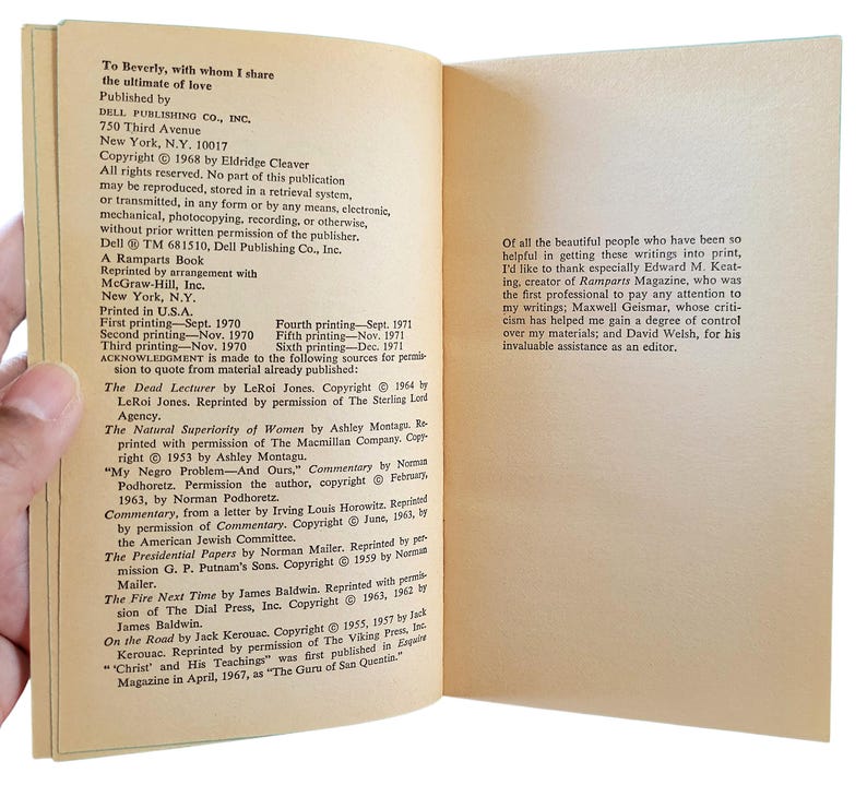 May include: Open book pages with text, including copyright information and acknowledgments. The left page lists book titles and authors, while the right page contains a thank you note. The book is held by a hand.