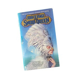 May include: A white ceramic mug with a black handle and the text "But First, Coffee" in a handwritten style. The mug is on a white surface. The mug is likely for hot beverages.