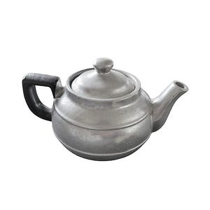 May include: A silver-colored teapot with a rounded body, a lid with a small knob, and a curved spout. The handle is black. The teapot is made of metal and has a classic design.