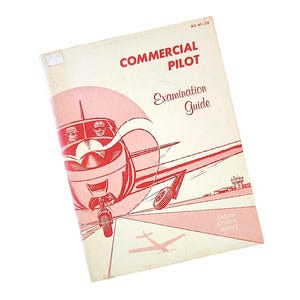 May include: Vintage "Commercial Pilot Examination Guide" book. The cover features a red and white illustration of a plane with two pilots, and the text "Commercial Pilot" and "Examination Guide". The Federal Aviation Agency logo is also visible.