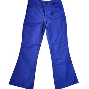 May include: A pair of bright blue flared pants. The pants have a classic five-pocket design with a button and zipper closure. The fabric appears to be a medium-weight denim or similar material. The pants are displayed on a white background.