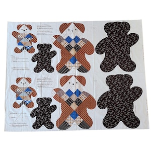 May include: A white fabric panel with several teddy bear designs. Some bears are patchwork with brown, blue, and white patterns. Others are solid brown with a floral design. Instructions are printed on the panel.