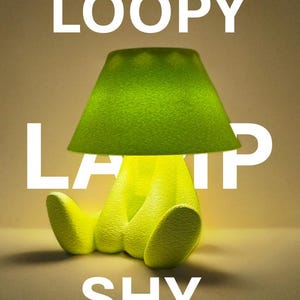 May include: A whimsical lime green lamp with a matching lampshade. The lamp's base is shaped like a seated figure. The word "LOOPY" is at the top, "LAMP" in the middle, and "SHY" at the bottom in white block letters.