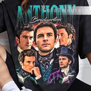 May include: Black t-shirt featuring a graphic of the word "ANTHONY" in teal, with the name "Bridgerton" below. The shirt displays portraits of several men in period attire. The text "edolormastore" is visible.