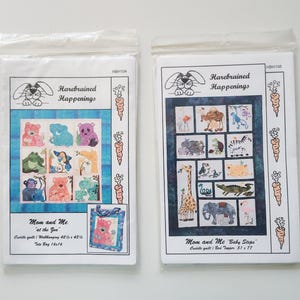 May include: Two sewing pattern packets titled Harebrained Happenings. The left packet, HBH104, shows a blue quilt with animal illustrations and a tote bag. The right packet, HBH106, features a dark blue quilt with various zoo animal designs.
