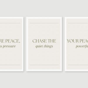 May include: Three framed art prints with inspirational quotes. The prints feature the phrases "MORE PEACE, less pressure", "CHASE THE quiet things", and "YOUR PEACE IS powerful" in a minimalist design. The frames are white, and the background is a light beige.