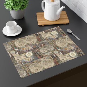 May include: A rectangular placemat featuring a vintage-style collage of antique world maps, celestial diagrams, and historical illustrations. The design includes circular map projections, ornate borders, and the text ATLAS printed in a classic serif font.