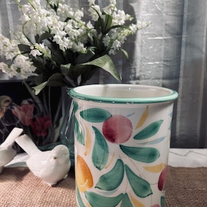 May include: A set of three ceramic mugs with a speckled, matte finish. The mugs are in shades of cream, light gray, and dark gray. Each mug has a simple, minimalist design, perfect for coffee or tea.