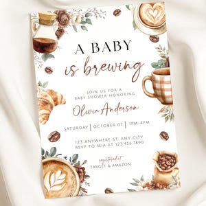 May include: Baby shower invitation with watercolor illustrations of coffee, a croissant, and floral accents. The text reads "A Baby is Brewing" and includes event details and the name Olivia Anderson.