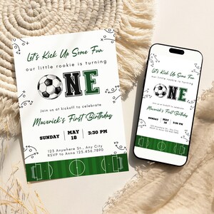 May include: A soccer-themed first birthday invitation and a smartphone displaying the same design. The invitation features a soccer ball graphic, the word "ONE", and the text "Let's Kick Up Some Fun". The invitation includes the date, time, and location.