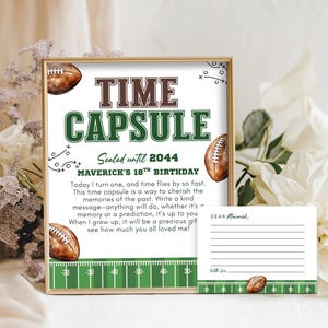 May include: A framed time capsule sign with football graphics and the text "TIME CAPSULE" in brown and green. The sign includes the text "Sealed until 2044" and "MAVERICK'S 18TH BIRTHDAY". A matching card is included.