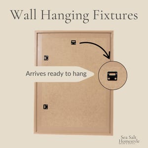 May include: A rectangular wall hanging fixture with a light brown frame and backing. The text "Wall Hanging Fixtures" is at the top. The text "Arrives ready to hang" is on the left. A close-up of the hanging hardware is on the right.