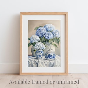 Botanical hydrangea print of blue hydrangeas in ginger jars, with white mat and natural wood frame, shown framed or unframed. Grandmillennial art print with blue hydrangea flowers in a timeless vintage design.