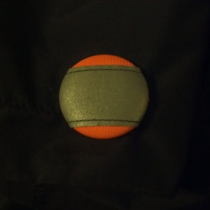 May include: Orange and grey dog toy with a textured surface.