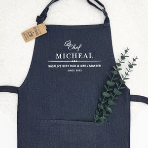 a black apron with a white label on it