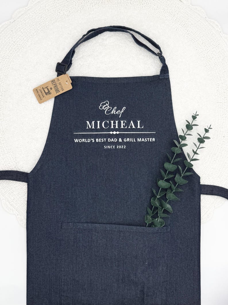 a black apron with a white label on it