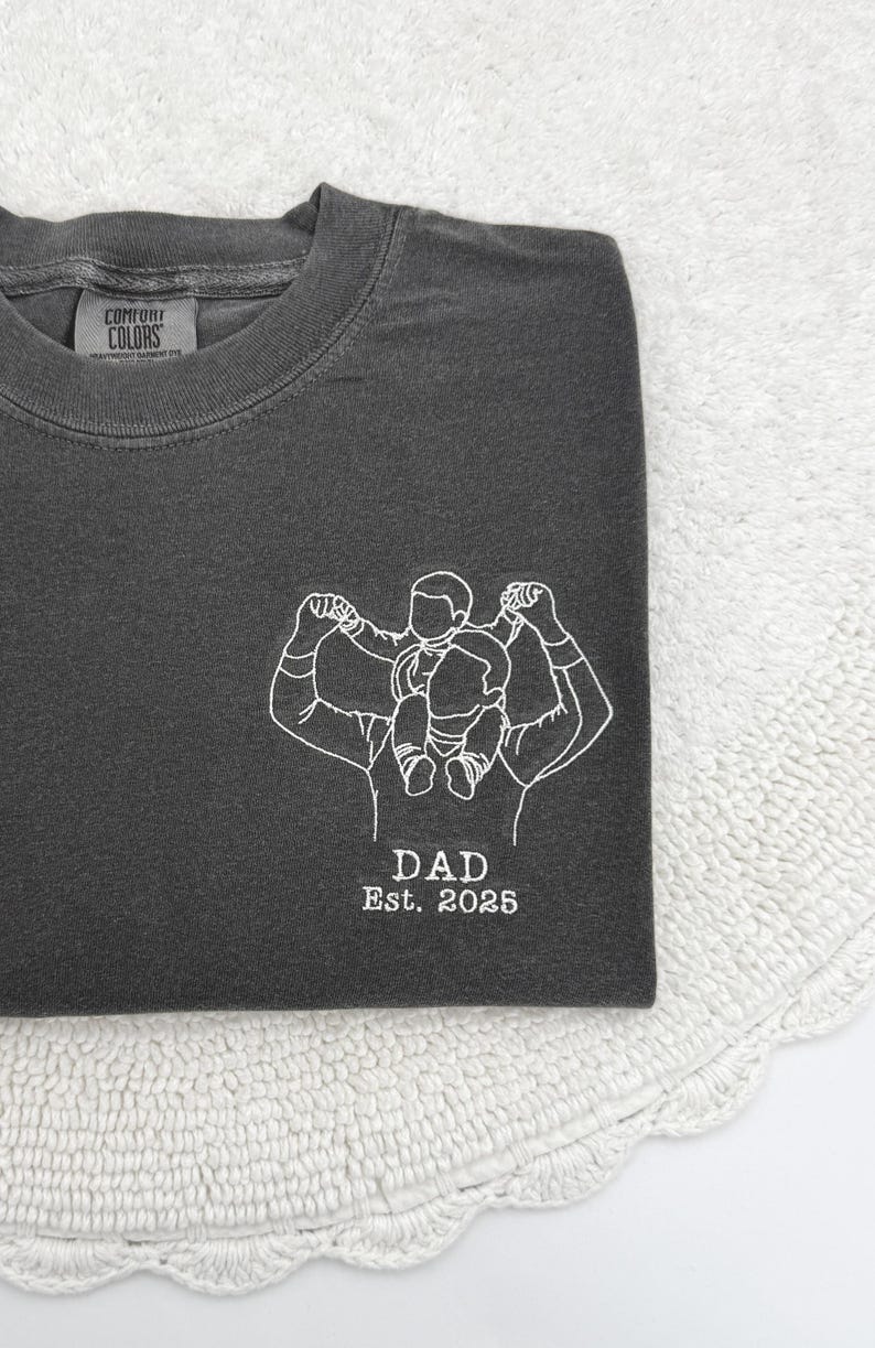 a t - shirt with a picture of a man lifting a barbell