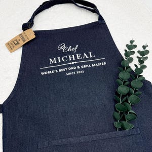 a black apron with a white label on it