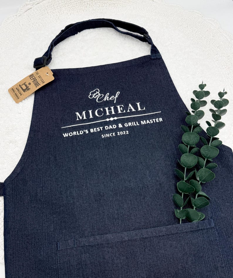 a black apron with a white label on it