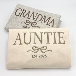 a pair of personalized towels with a bow on them
