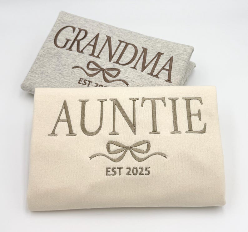 a pair of personalized towels with a bow on them