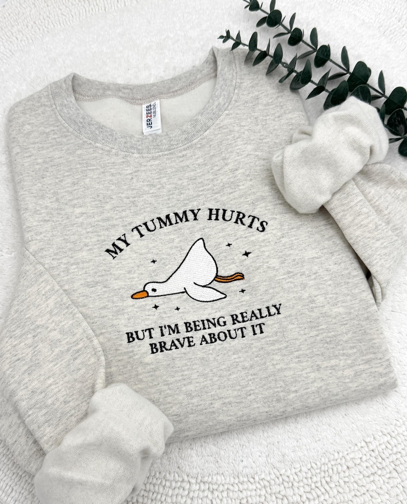 a sweater with a picture of a bird on it