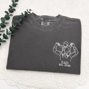 a t - shirt with a picture of a man and a woman on it