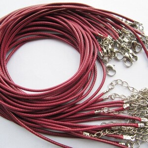 May include: A bundle of 25 burgundy waxed cotton cords with silver lobster clasps. The cords are approximately 18 inches long and are ideal for making necklaces, bracelets, or other jewelry.