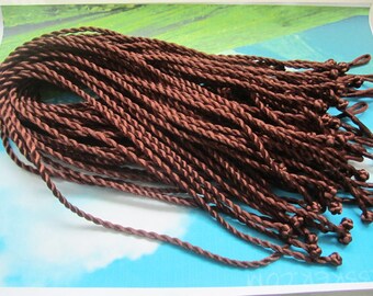 May include: A bundle of brown twisted cords with knots at the ends. The cords are approximately 18 inches long.