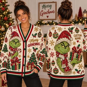 May include: A cream-colored V-neck cardigan featuring a green Grinch character, red and green Christmas ornaments, trees, and snowflakes. The front displays the text Merry GRINCHMAS, while the back includes the text CUSTOM NAME.