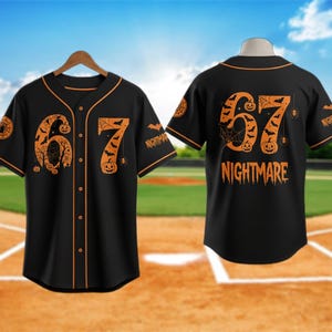 May include: Black baseball jersey with orange accents and a Halloween theme. The front features the number "67" with a spooky design, while the back displays "67" and the word "NIGHTMARE". Includes a spider web, bats, and jack-o'-lanterns.