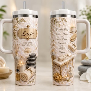 May include: Two light beige tumblers with handles and straws featuring spa-themed graphics. One displays the name Lucia, the text Self Care Isn't Selfish, a lotus, stones, and candles. The other lists Breathe Deep, Release Stress, Find Peace, Unwind, Relax, Repeat with massage table imagery.